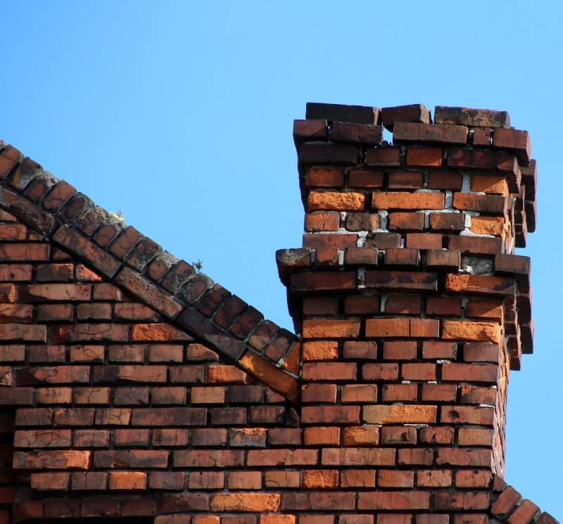 Signs Your Corinth Home Needs a Chimney Inspection Damaged chimney on an Corinth home showing cracks and missing mortar